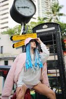 Portrait of Young girl with blue hair, teenage standing on street as urban life. photo