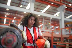 Female worker Foreman or worker work at factory site check up machine or products in site. Engineer or Technician checking Material or Machine on Plant. Industrial and Factory. photo