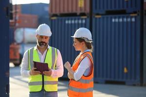 Foreman checking containers in the terminal, at import and export business logistic company. photo