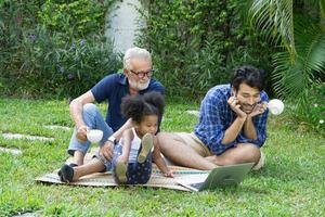 Portrait of happy Mixed race family with little kids sit relax on couch cuddling, parents rest on sofa hug preschooler children at home together photo