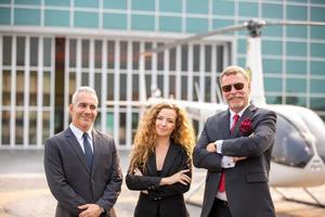 Successful business people standing together widen out showing strong relationship of worker community. A team of businessman and businesswoman expressing a strong group teamwork at the modern office. photo