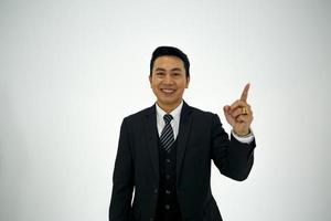 Business man pointing against white background. photo