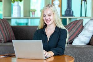 Young blonde hair women using laptop at home.