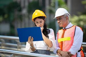 The engineer and business people hand high five against building. The concept of engineering, construction, city life and future. photo