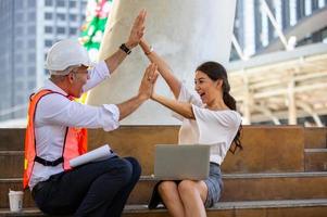 The engineer and business people hand high five against building. The concept of engineering, construction, city life and future. photo