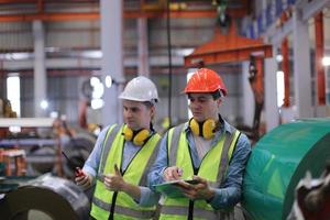 Industry worker Foreman or worker work at factory site check up machine or products in site. Engineer or Technician checking Material or Machine on Plant. Industrial and Factory. photo