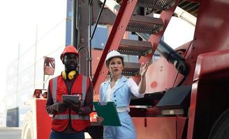 Foreman checking containers in the terminal, at import and export business logistic company. photo
