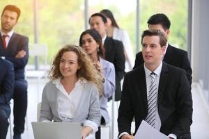 Speaker giving presentation in hall. Audience or conference hall. Rear view of unrecognized participants in audience. Scientific conference event, training photo