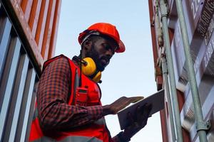 Foreman control loading Containers box from Cargo freight ship for import export. photo