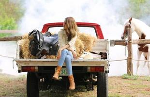 Young woman with her horse in evening sunset light. Outdoor photography with fashion model girl. Lifestyle mood photo