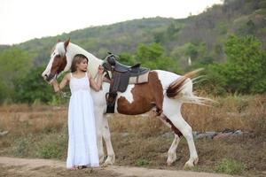 Young woman with her horse in evening sunset light. Outdoor photography with fashion model girl. Lifestyle mood photo