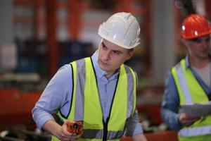 Industry worker Foreman or worker work at factory site check up machine or products in site. Engineer or Technician checking Material or Machine on Plant. Industrial and Factory. photo