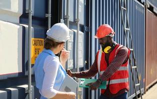 Foreman checking containers in the terminal, at import and export business logistic company. photo
