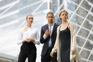 Successful business people standing together widen out showing strong relationship of worker community. A team of businessman and businesswoman expressing a strong group teamwork at the modern office. photo