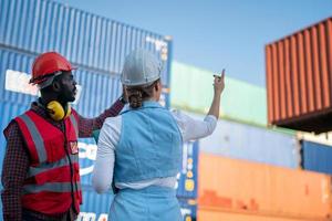 Foreman checking containers in the terminal, at import and export business logistic company. photo