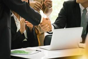 Business people shaking hands after successful negotiations photo