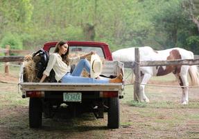 Young woman with her horse in evening sunset light. Outdoor photography with fashion model girl. Lifestyle mood photo