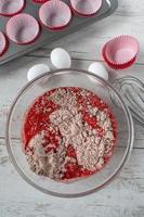 red velvet cake batter with ingredients and cupcake tin flat lay photo