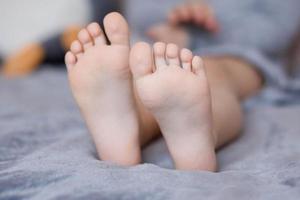 Children's feet are brought together in close-up photo