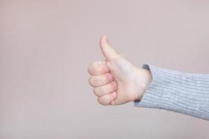 Close-up of a child's hand of a girl showing a Like. Baby hand, thumbs up Baby hand shows like. photo