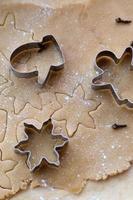 Rolled ginger dough on the table with Christmas cookie cutters. Silhouettes on the test. Christmas Cookies viewed from above photo