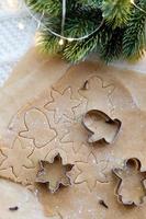 Ginger dough for Christmas gingerbread and cookie cutters on table photo