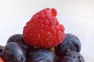 Raspberries and blueberries close-up. Macro berry photo