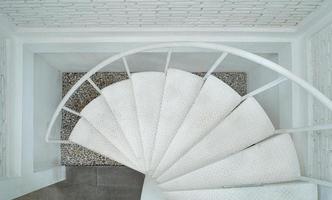 Metal white spiral staircase, interior architecture of building photo