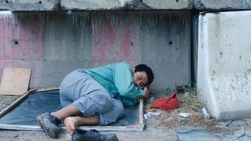 A man lying by the wall photo