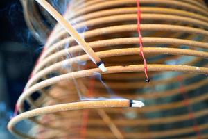 Burned coil swirl incense in Macau Macao temple, traditional Chinese cultural customs to worship god, close up, lifestyle. photo