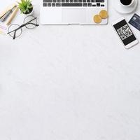 Online payment with QR code concept, virtual credit card, smart phone on office laptop desk on clean marble table background, top view, flat lay photo