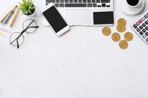 Concept of online payment with credit card with smart phone, laptop computer on office desk on clean bright marble table background, top view, flat lay photo