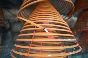 Burned coil swirl incense in Macau Macao temple, traditional Chinese cultural customs to worship god, close up, lifestyle. photo