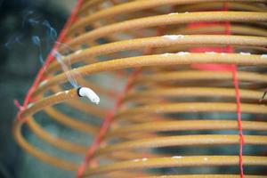 Burned coil swirl incense in Macau Macao temple, traditional Chinese cultural customs to worship god, close up, lifestyle. photo