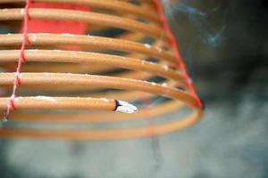 Burned coil swirl incense in Macau Macao temple, traditional Chinese cultural customs to worship god, close up, lifestyle. photo