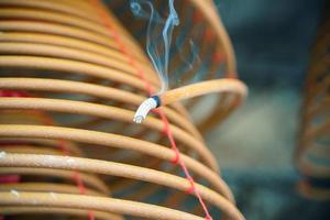 Burned coil swirl incense in Macau Macao temple, traditional Chinese cultural customs to worship god, close up, lifestyle. photo