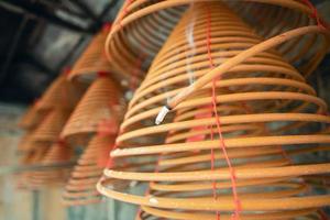 Burned coil swirl incense in Macau Macao temple, traditional Chinese cultural customs to worship god, close up, lifestyle. photo