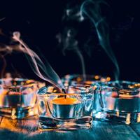 Halloween holiday concept design of pumpkin, candle, spooky decorations with green tone smoke around on a dark wooden table, close up shot. photo