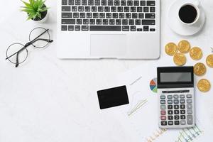 Concept of online payment with credit card with smart phone, laptop computer on office desk on clean bright marble table background, top view, flat lay photo