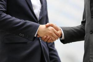 Businessman handshake for teamwork of business merger and acquisition,successful negotiate,hand shake,two businessman shake hand with partner to celebration partnership and business deal concept photo