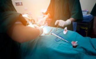 Blurred background of modern operating room at hospital with Group of surgeons in operating room with surgery equipment. Modern medical background photo