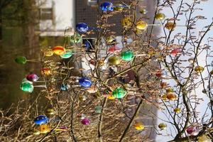 Colorful Easter Eggs On The Tree In The Garden At A Sunny Day. photo