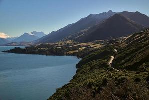 Road to the mountains next to the lake photo