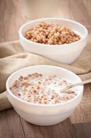 Buckwheat porridge in a bowl on a wooden table photo