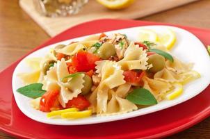 Spanish salad with pasta bows, tomatoes and chicken photo