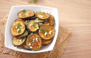 Platter of grilled eggplant with garlic and dill photo