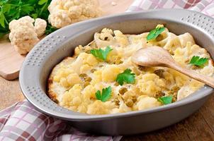 cauliflower baked with egg and cheese with green peas photo