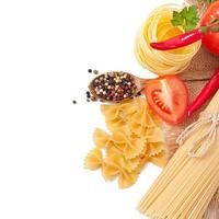 Pasta spaghetti, vegetables, spices isolated on white photo