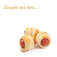 Sausages in dough isolated on white background photo