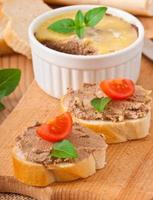 Homemade chicken liver pate, basil and slices of white bread photo